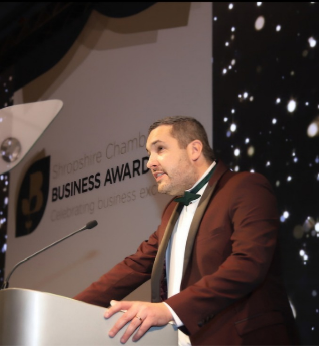 Chris G Jones speaking at an awards event